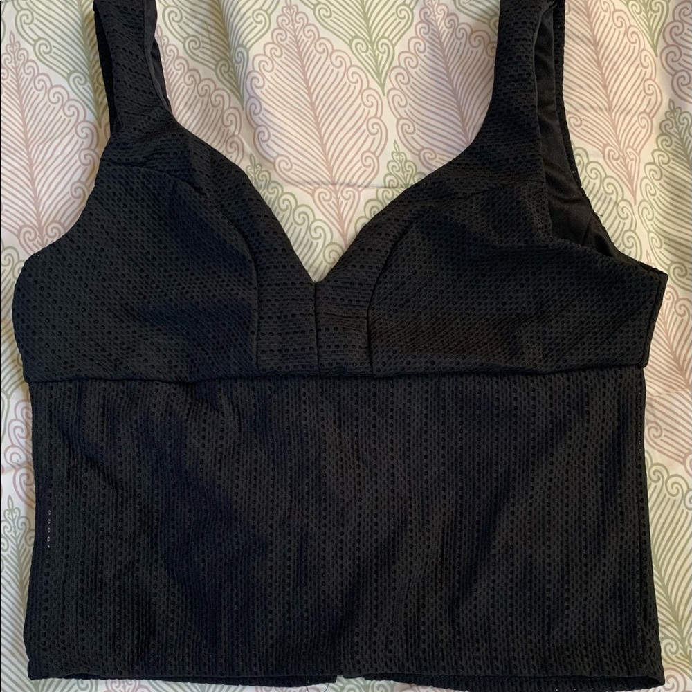 A black crop top with zipper on the back.
